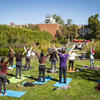 students participating in a group stretching session.